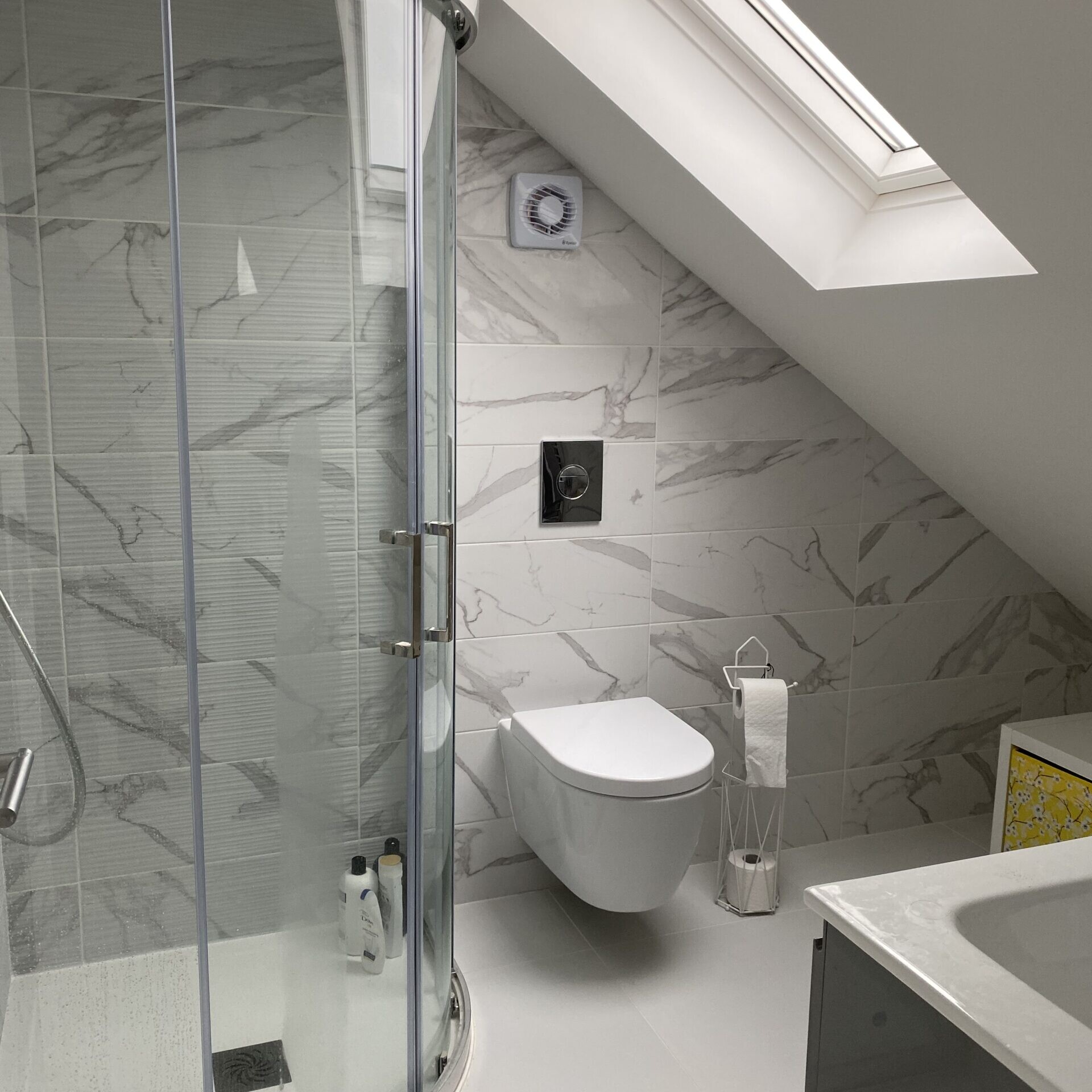 Image shows a newly installed shower room in a loft conversion completed by SureBuild Homes