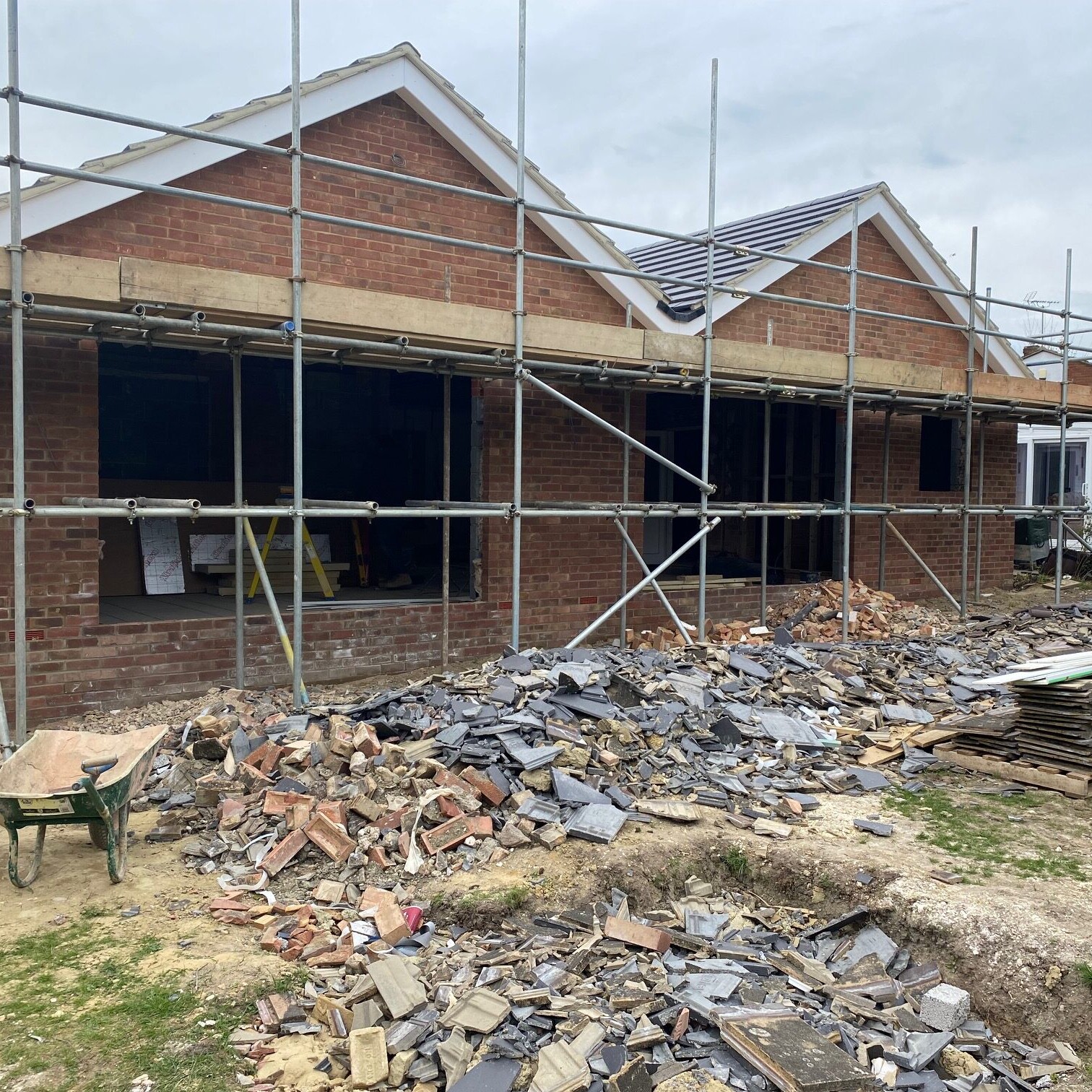 Image shows a bungalow with an extension underway