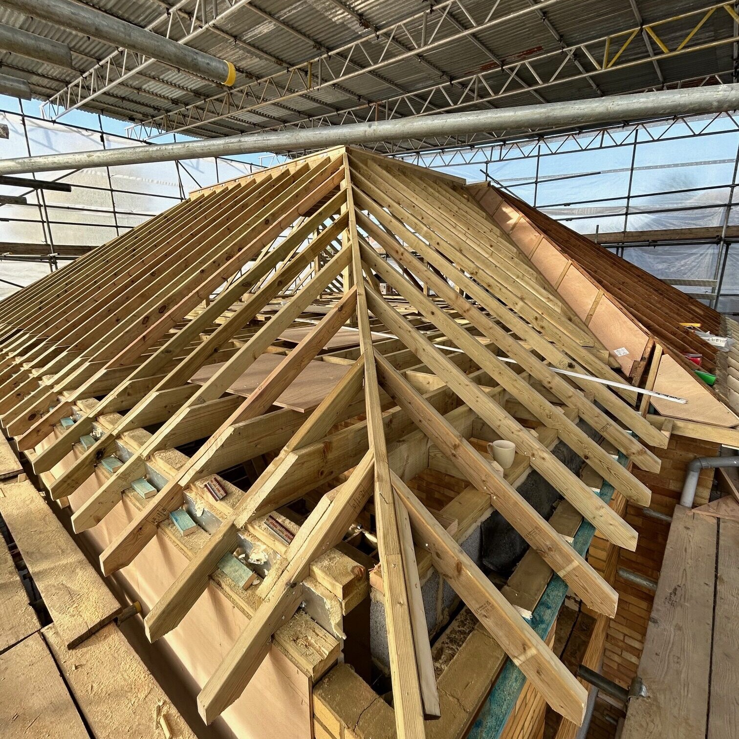 Image shows the rafters of a roof during the installation as part of an extension